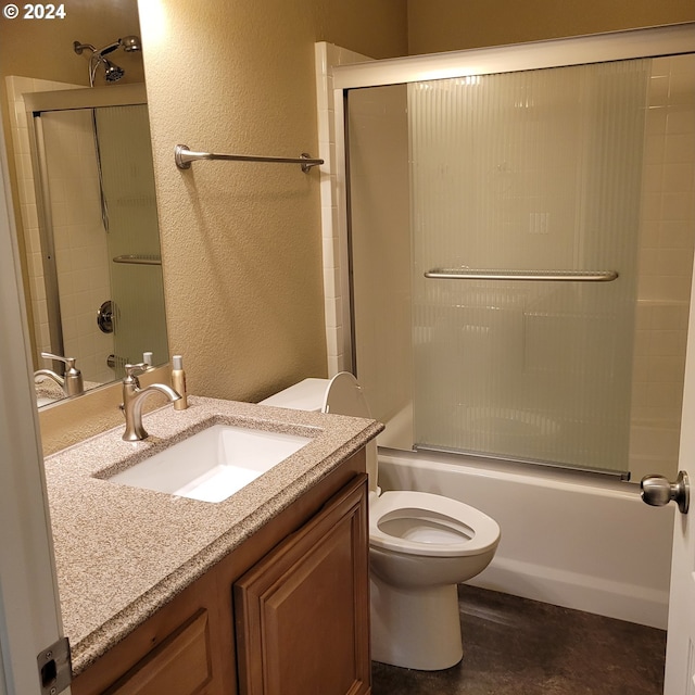 full bathroom with vanity, toilet, and bath / shower combo with glass door