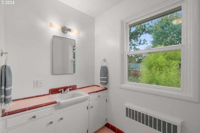 bathroom featuring radiator and vanity