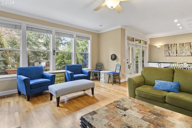 living room with ceiling fan, a healthy amount of sunlight, and light hardwood / wood-style floors