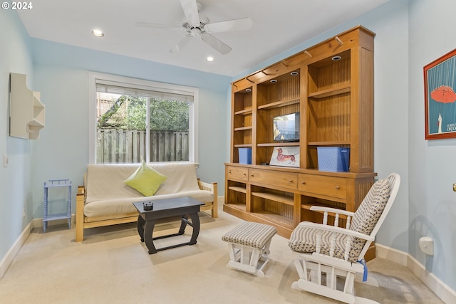 sitting room with light carpet and ceiling fan