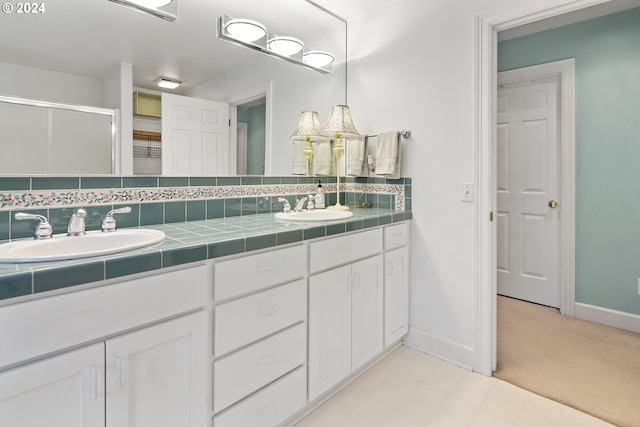 bathroom featuring backsplash, tile floors, and double sink vanity