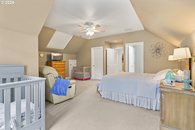 carpeted bedroom featuring ceiling fan and vaulted ceiling