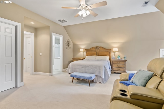 bedroom with lofted ceiling, ensuite bath, ceiling fan, and light colored carpet