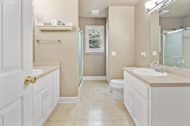 bathroom featuring toilet, tile flooring, an enclosed shower, and vanity