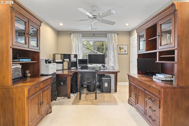 office space featuring light carpet and ceiling fan