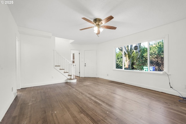 unfurnished living room featuring dark hardwood / wood-style floors and ceiling fan