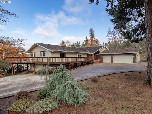 ranch-style house with an outbuilding, a deck, and a garage