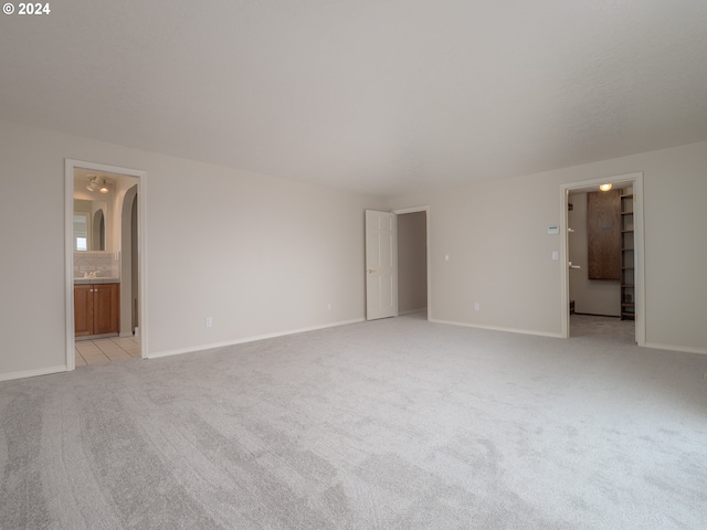 unfurnished room featuring light carpet