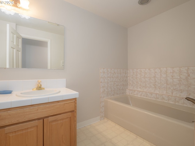 bathroom with vanity and a tub