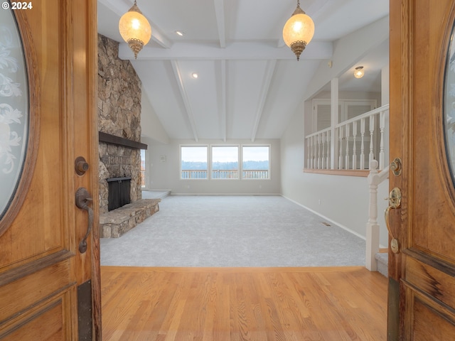 living room with a fireplace, lofted ceiling with beams, and light hardwood / wood-style flooring