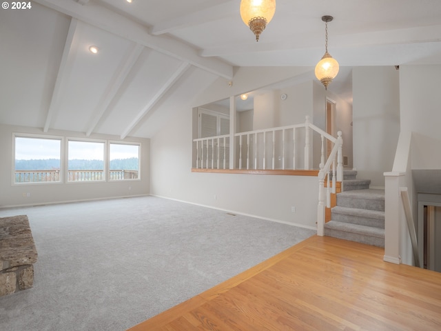 unfurnished living room featuring lofted ceiling with beams and light hardwood / wood-style floors