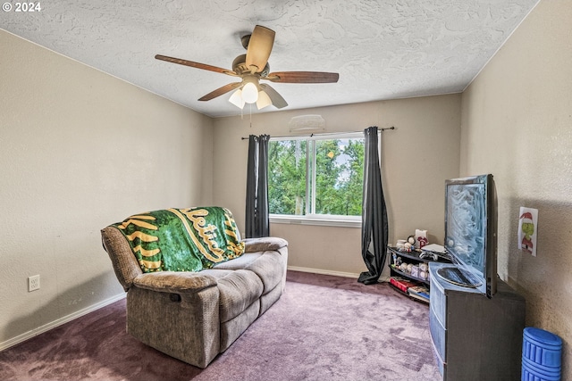 sitting room with a textured ceiling, carpet, and ceiling fan