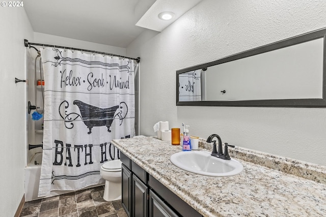 full bathroom featuring shower / bath combo with shower curtain, vanity, and toilet