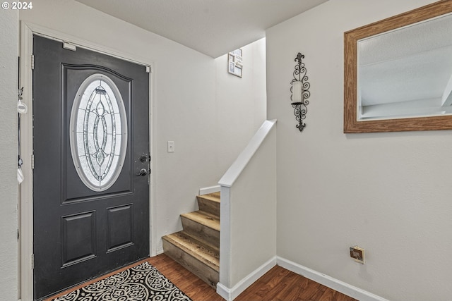 entryway featuring a textured ceiling and dark wood-type flooring