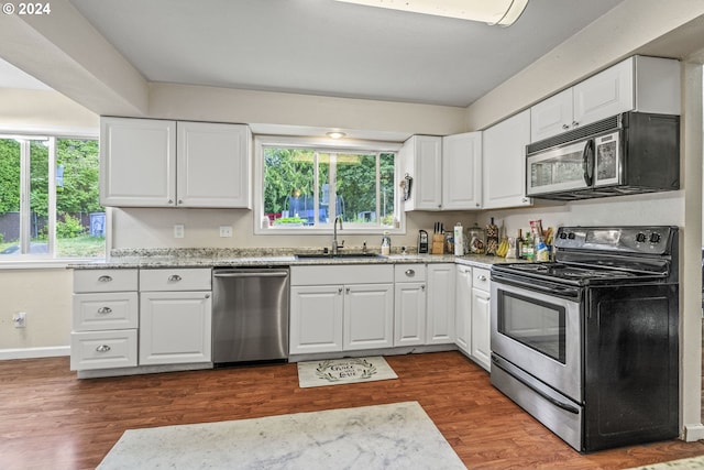 kitchen with white cabinetry, appliances with stainless steel finishes, plenty of natural light, and sink