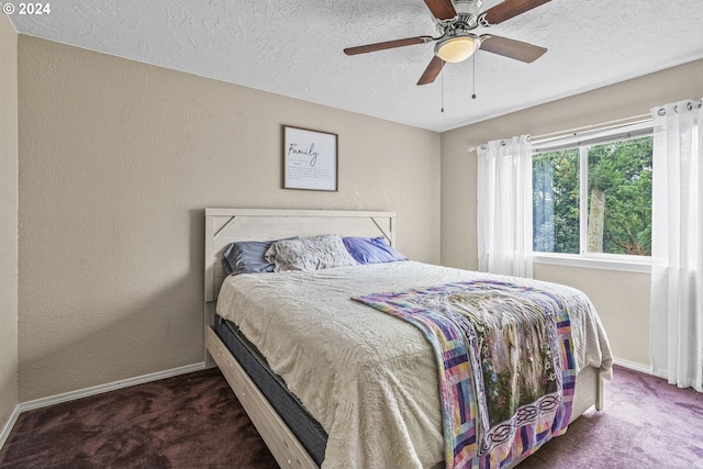 carpeted bedroom with ceiling fan and a textured ceiling