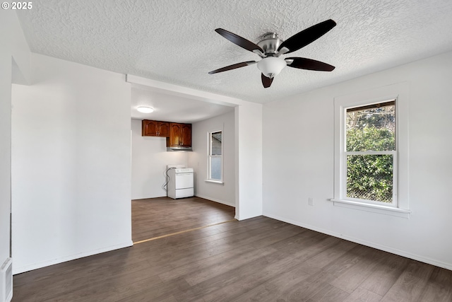 unfurnished living room featuring ceiling fan, dark hardwood / wood-style flooring, and a textured ceiling