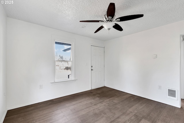 spare room with ceiling fan, dark hardwood / wood-style floors, and a textured ceiling