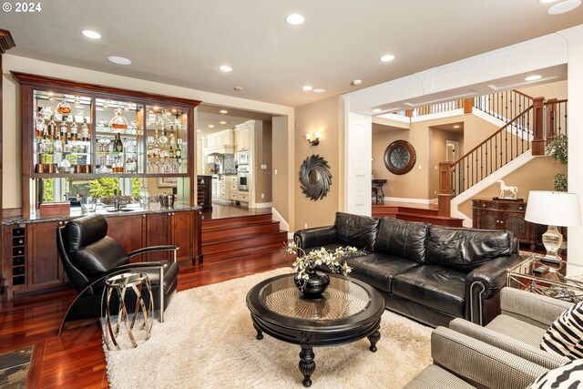 living room featuring dark wood-type flooring and indoor bar