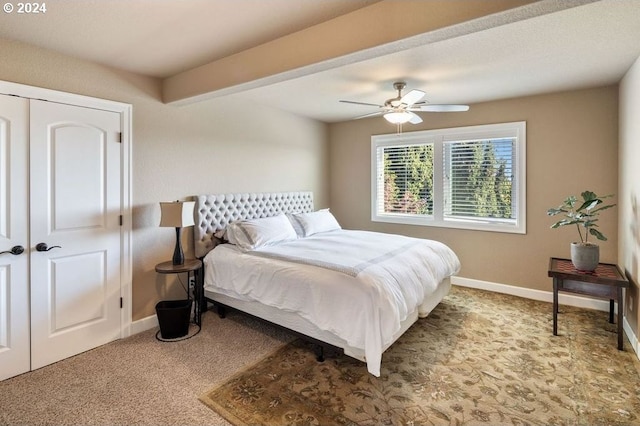 bedroom with ceiling fan, a closet, and light carpet