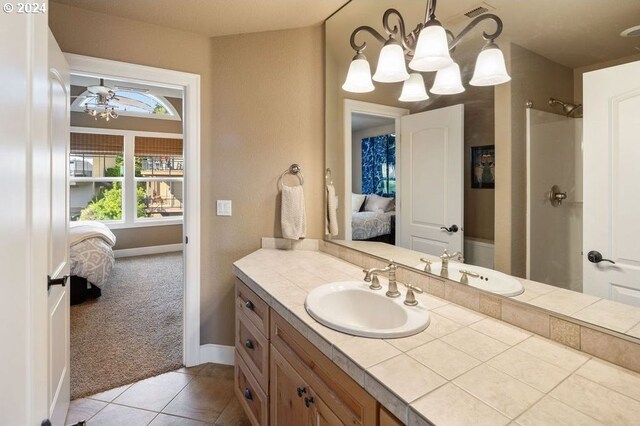 bathroom featuring vanity, tile patterned flooring, and ceiling fan with notable chandelier