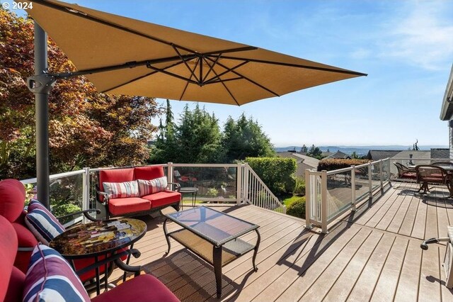 rear view of property with a wooden deck and a lawn