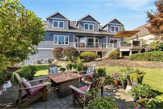 rear view of property featuring a patio area and a lawn