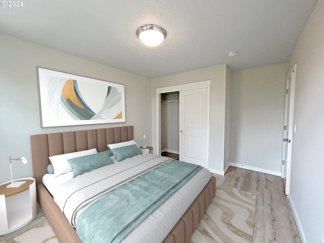 bedroom featuring a closet and light wood-type flooring