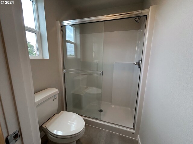 bathroom with toilet and walk in shower