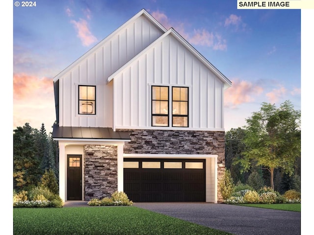 view of front of property featuring a garage and a yard