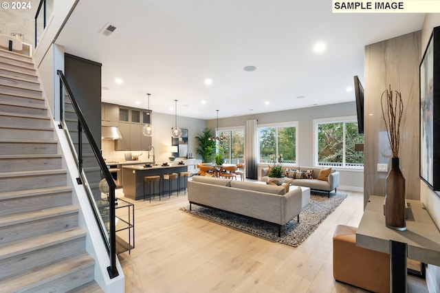 living room featuring sink and light wood-type flooring