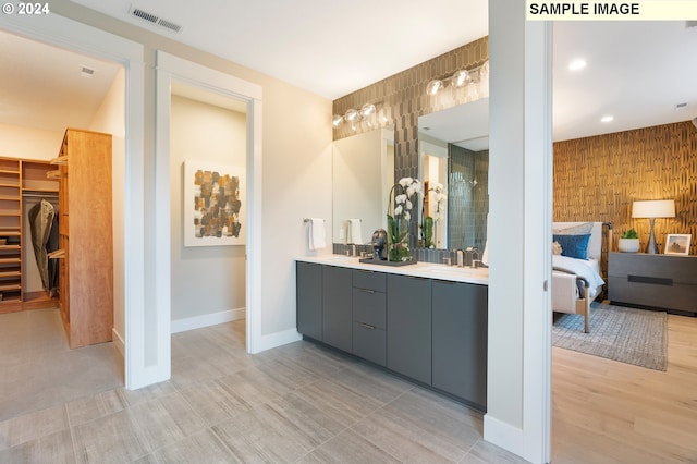 bathroom with dual vanity and tile patterned floors