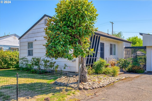 view of front of house with a front yard and fence