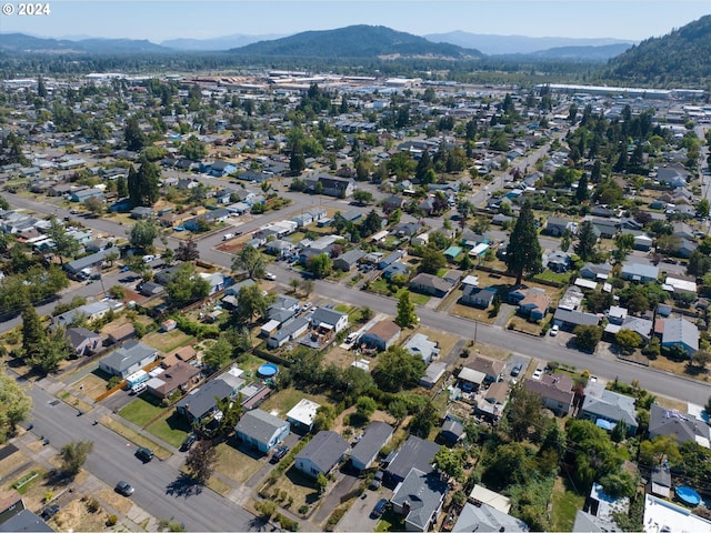 drone / aerial view featuring a residential view and a mountain view