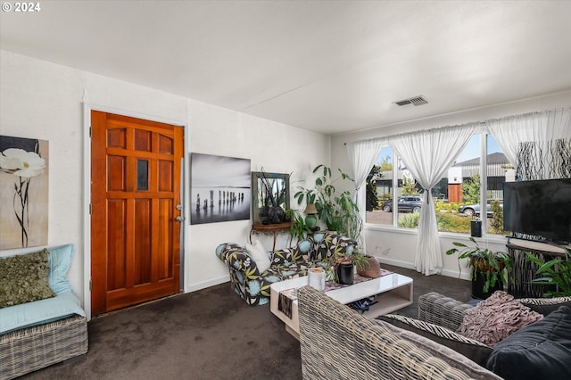 carpeted living area with visible vents and baseboards