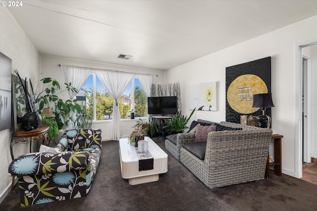 carpeted living room with visible vents and baseboards