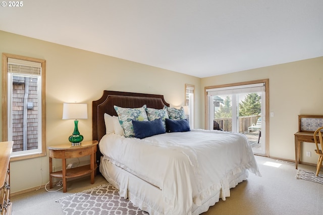 bedroom featuring baseboards, carpet, and access to exterior