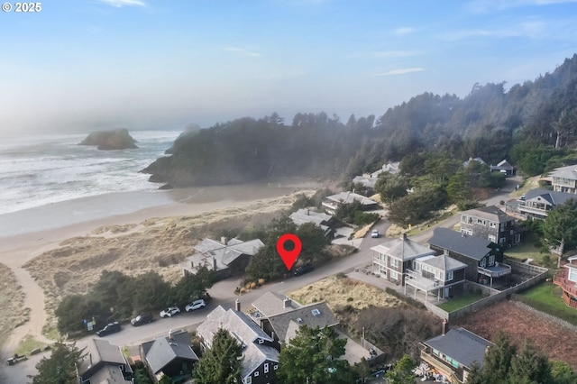 drone / aerial view with a beach view and a water view