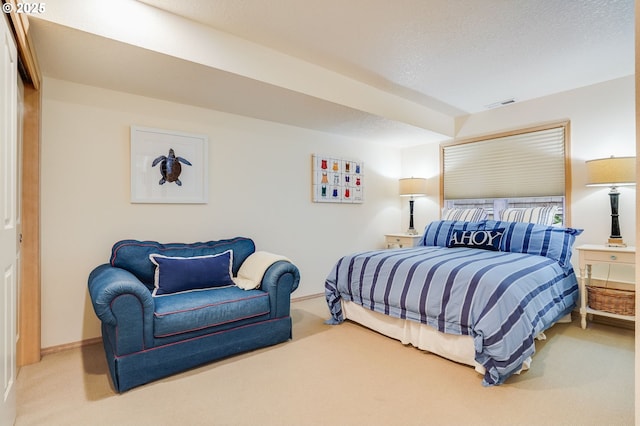 carpeted bedroom with baseboards, visible vents, and a textured ceiling