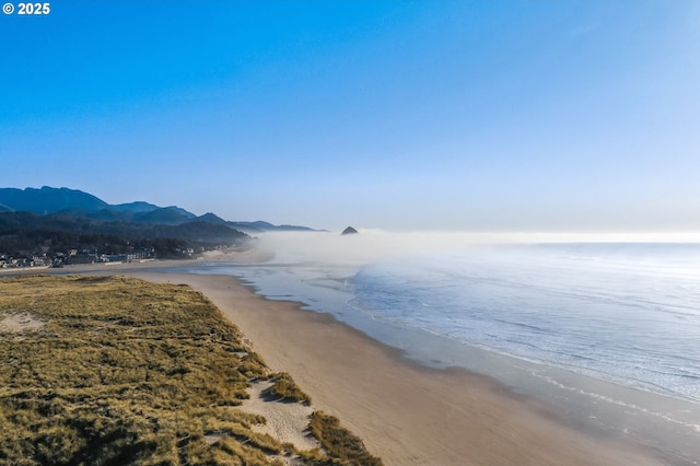 water view with a mountain view and a beach view