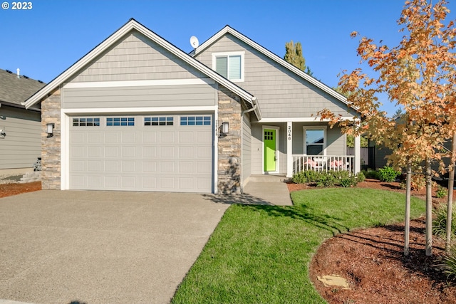 craftsman-style house with a porch, a front lawn, and a garage