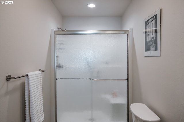 bathroom with toilet and walk in shower