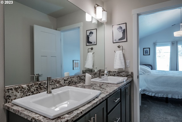 bathroom with vanity and lofted ceiling