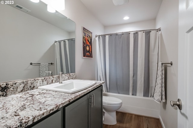 full bathroom featuring vanity, toilet, wood-type flooring, and shower / bath combo