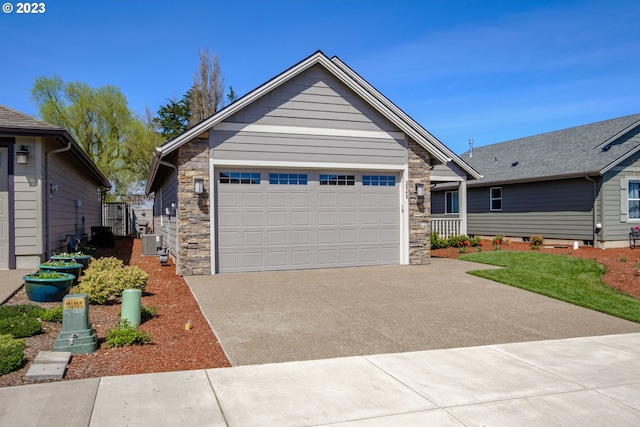 view of front of home featuring a garage and cooling unit