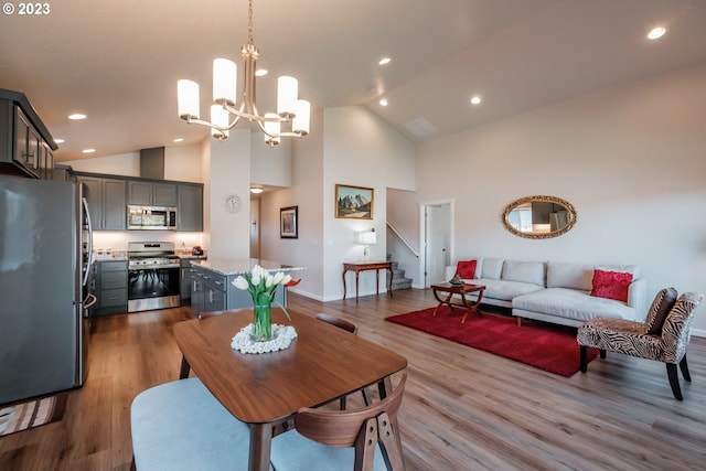 dining area featuring light hardwood / wood-style floors and high vaulted ceiling