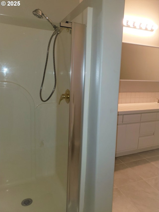 85287 Hemlock St, Florence, OR 97439 - bathroom featuring tasteful backsplash, vanity, tile patterned flooring, and a stall shower