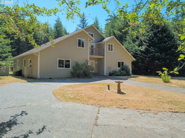85287 Hemlock St, Florence, OR 97439 - traditional-style home featuring a front yard, a balcony, and curved driveway