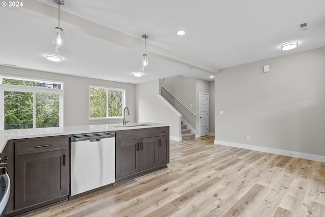 kitchen featuring stainless steel dishwasher, sink, light hardwood / wood-style flooring, and hanging light fixtures