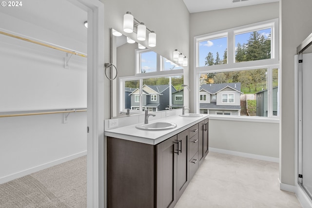 bathroom featuring lofted ceiling and double vanity